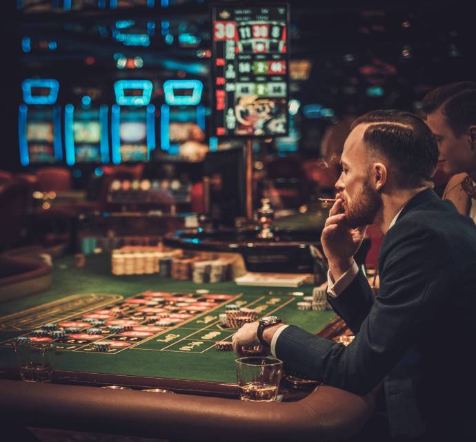 Upper class friends gambling in a casino.